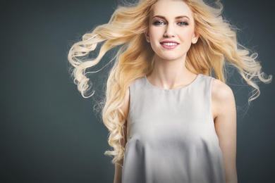 Photo of Portrait of young model with beautiful  hair on color background