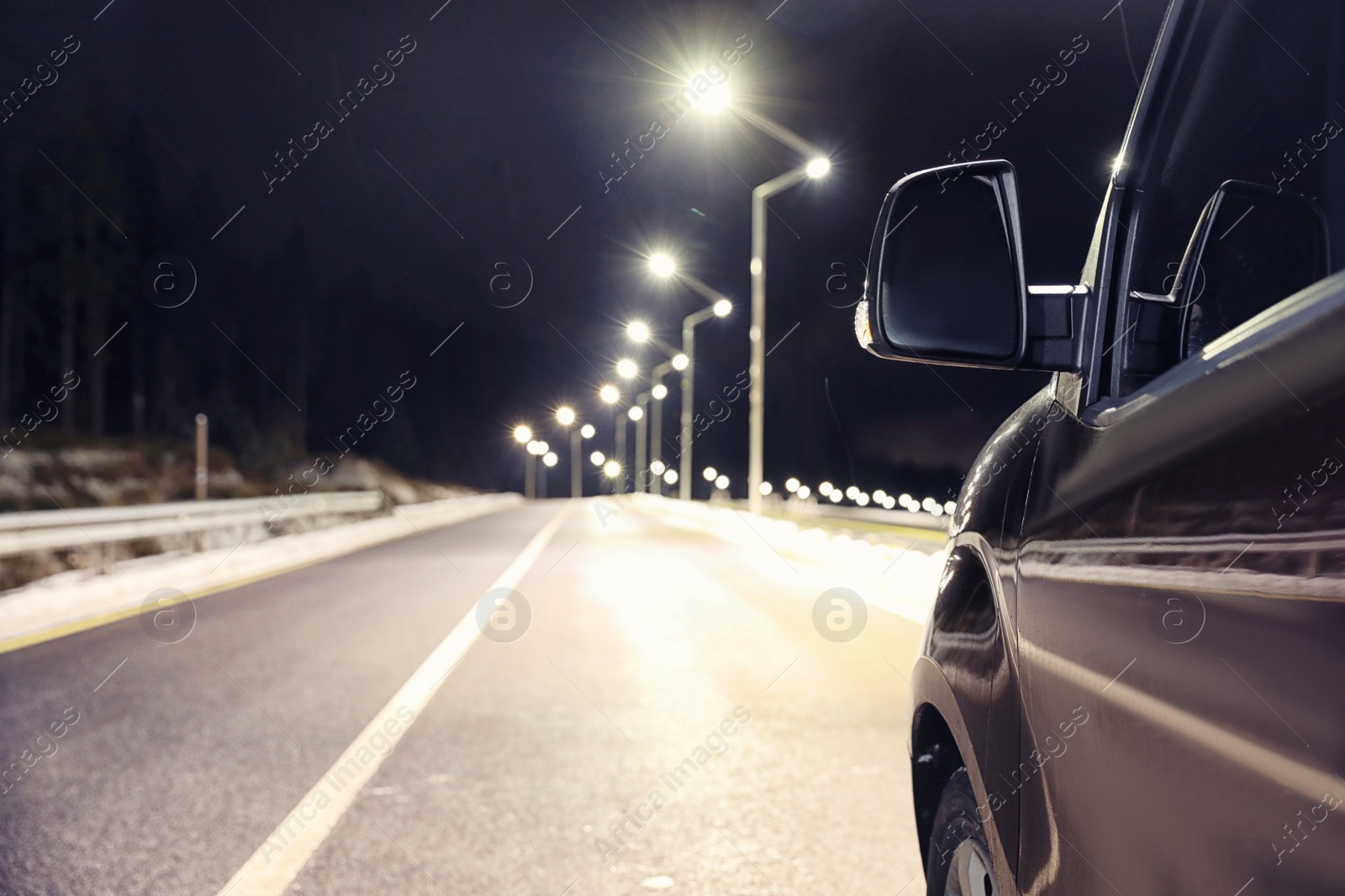 Photo of Modern car on asphalt road at night