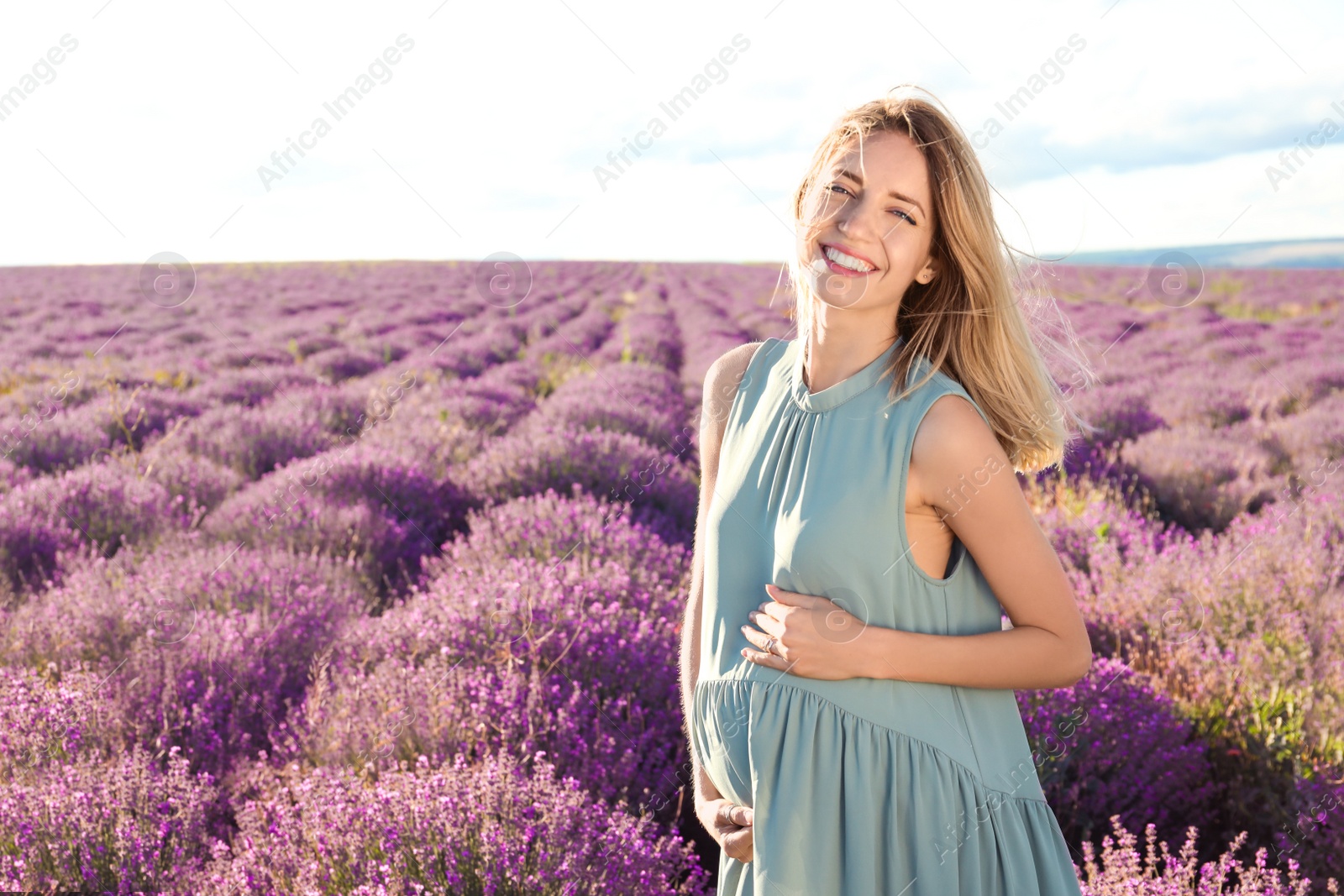 Photo of Pregnant woman in lavender field on summer day