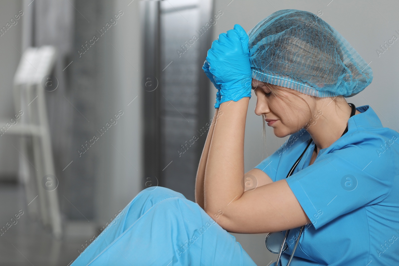 Photo of Exhausted doctor in hospital, space for text