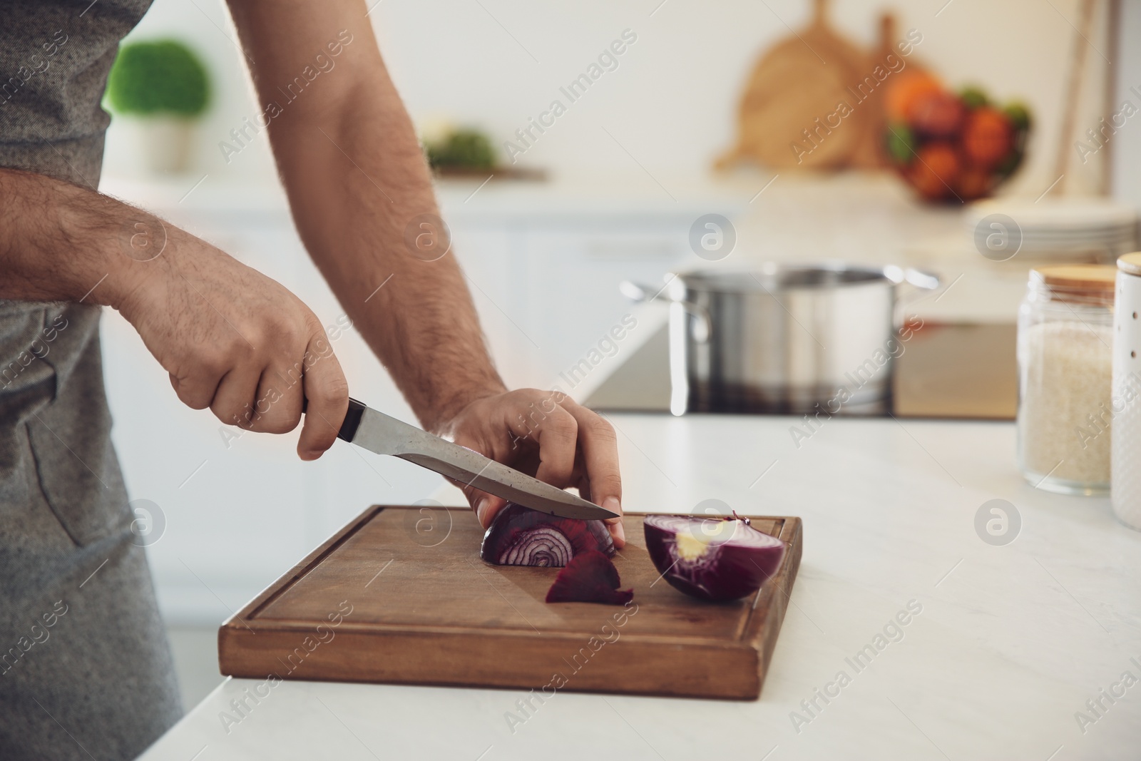 Photo of Man cooking at counter in kitchen, closeup