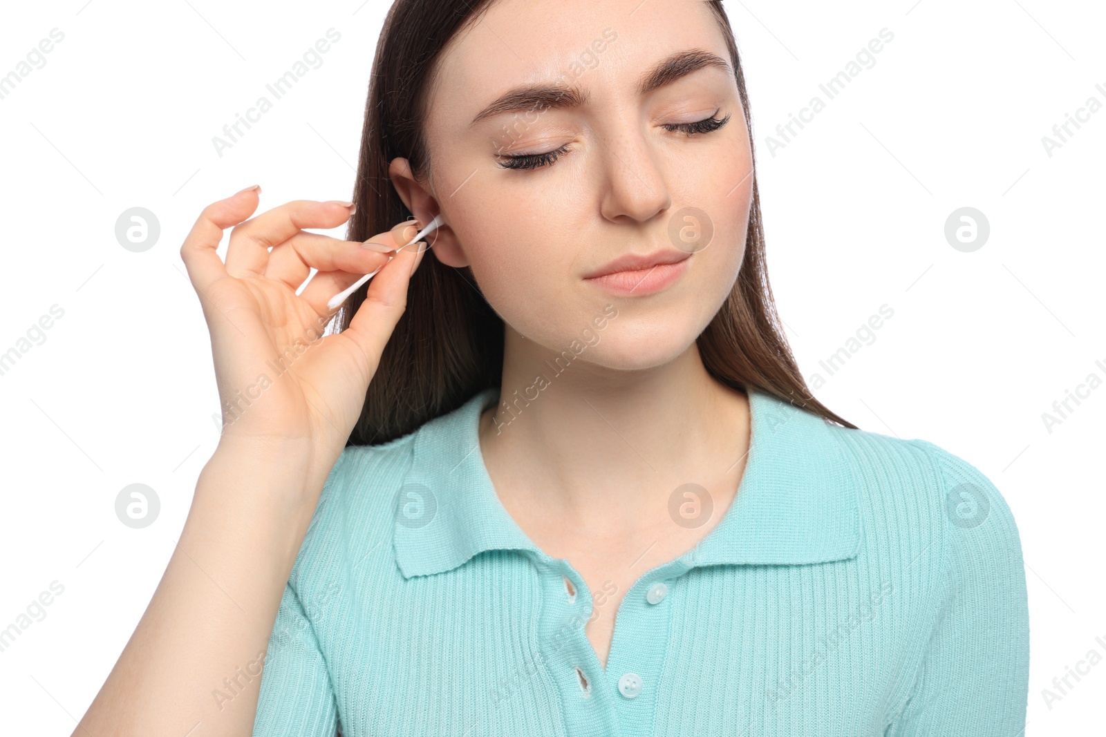 Photo of Young woman cleaning ear with cotton swab on white background, closeup