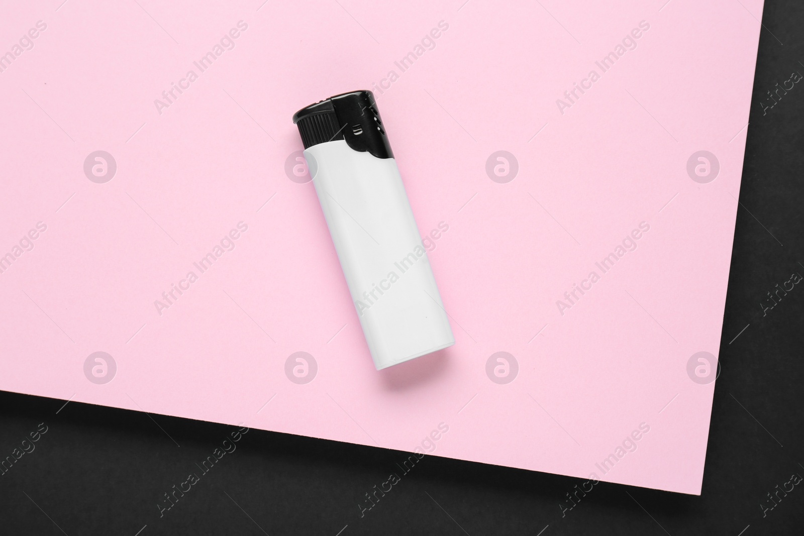 Photo of Stylish small pocket lighter on color background, top view