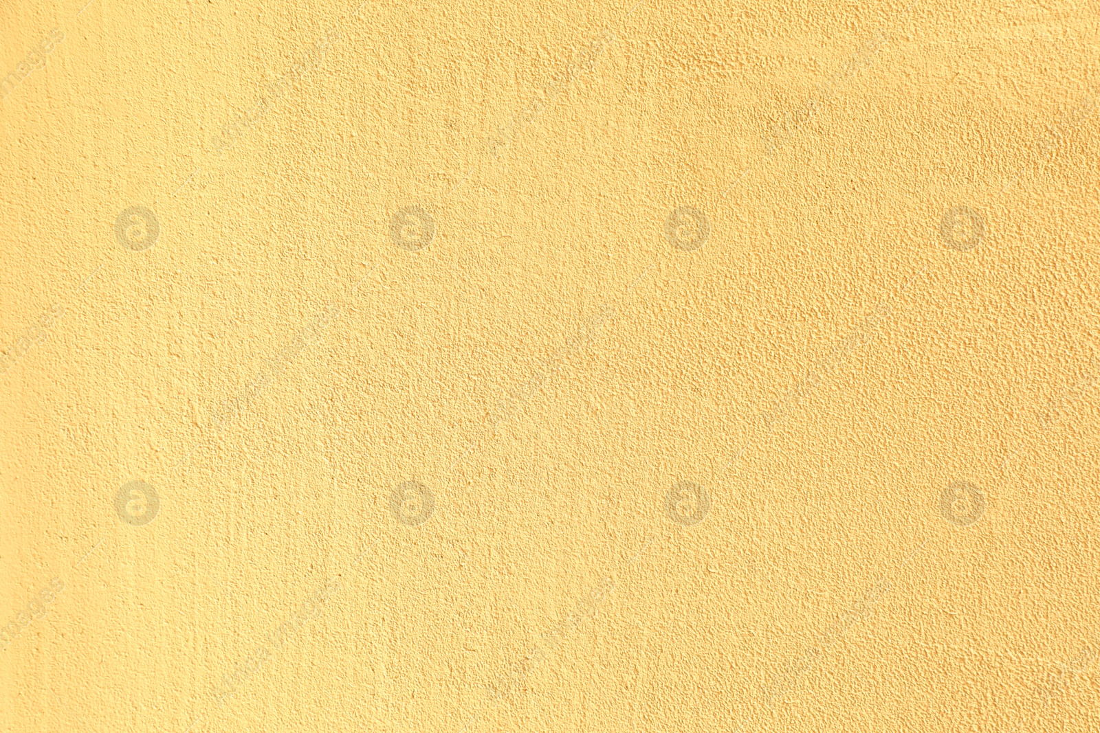 Photo of Texture of yellow plaster wall as background