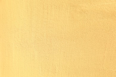 Texture of yellow plaster wall as background
