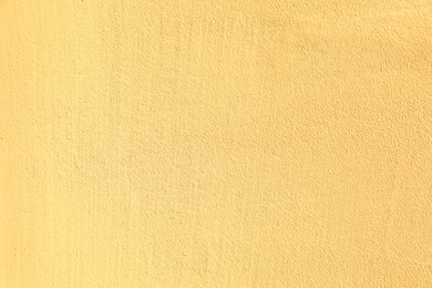 Photo of Texture of yellow plaster wall as background