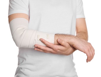 Photo of Man with arm wrapped in medical bandage on white background, closeup