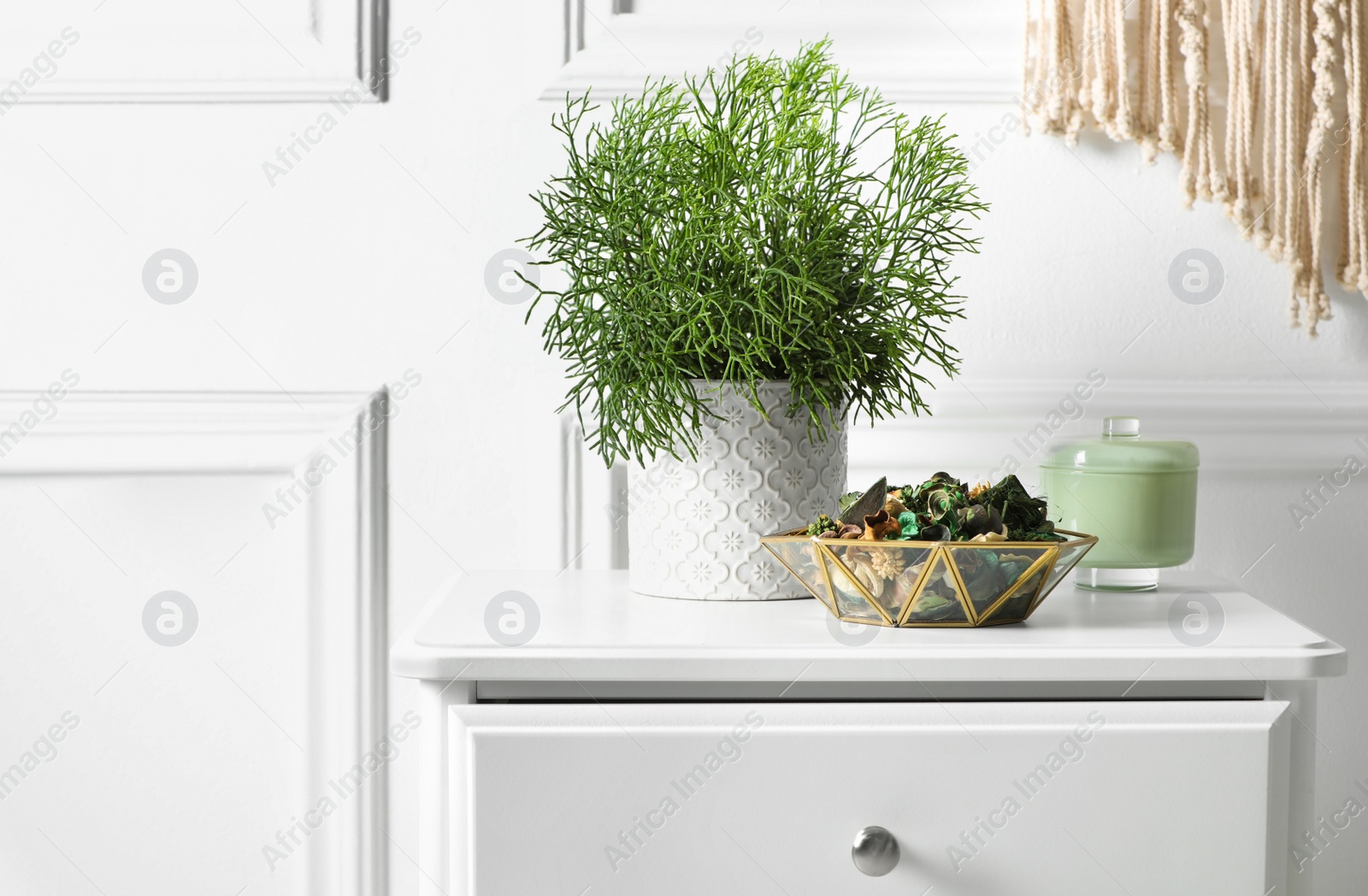 Photo of Aromatic potpourri of dried flowers and beautiful houseplant on white nightstand indoors