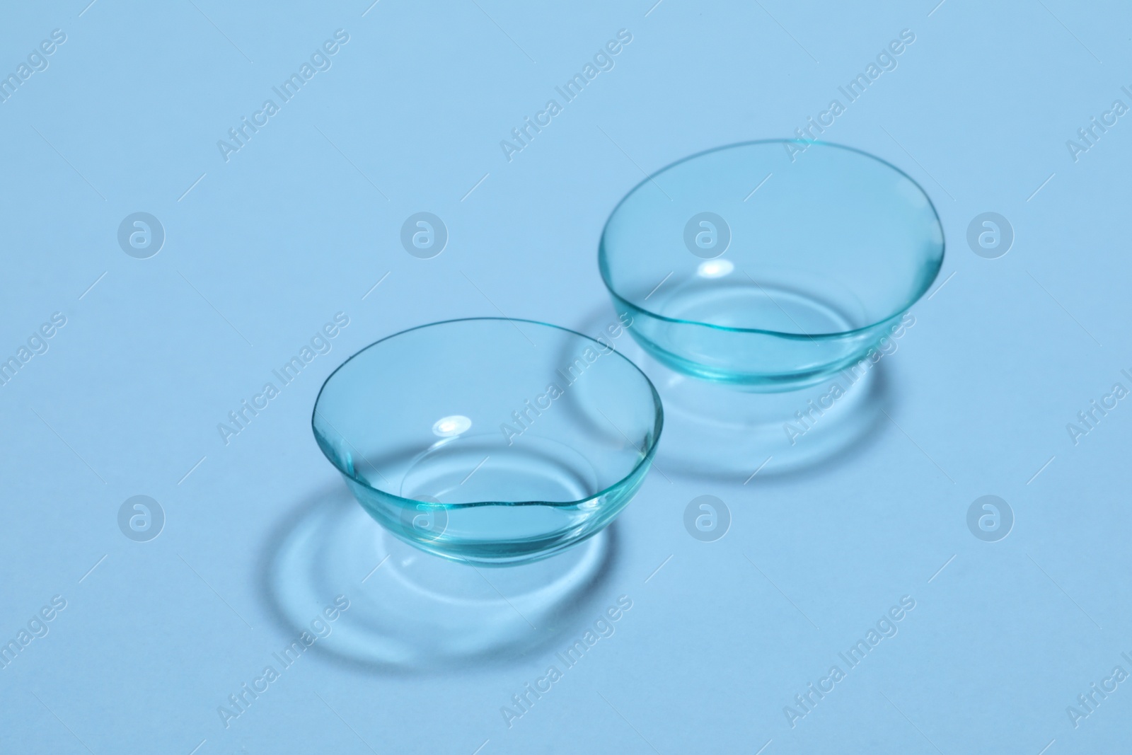 Photo of Pair of contact lenses on light blue background