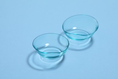 Photo of Pair of contact lenses on light blue background