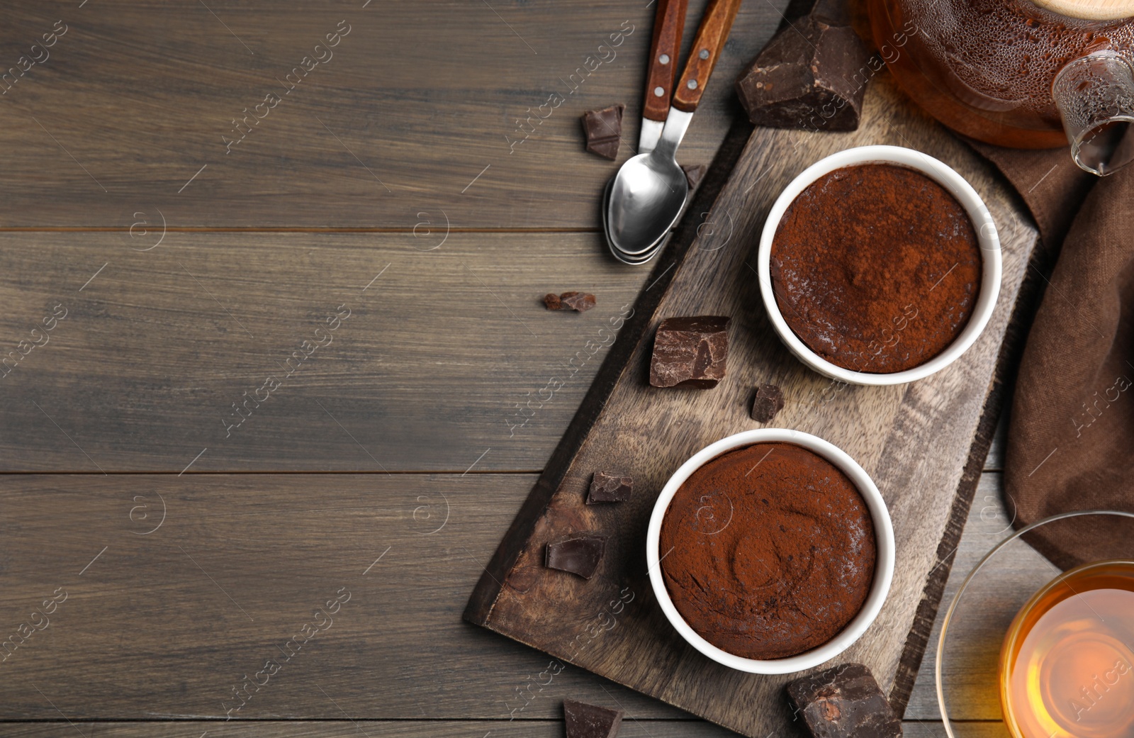 Photo of Delicious fresh fondant and chocolate chunks on wooden table, flat lay. Space for text