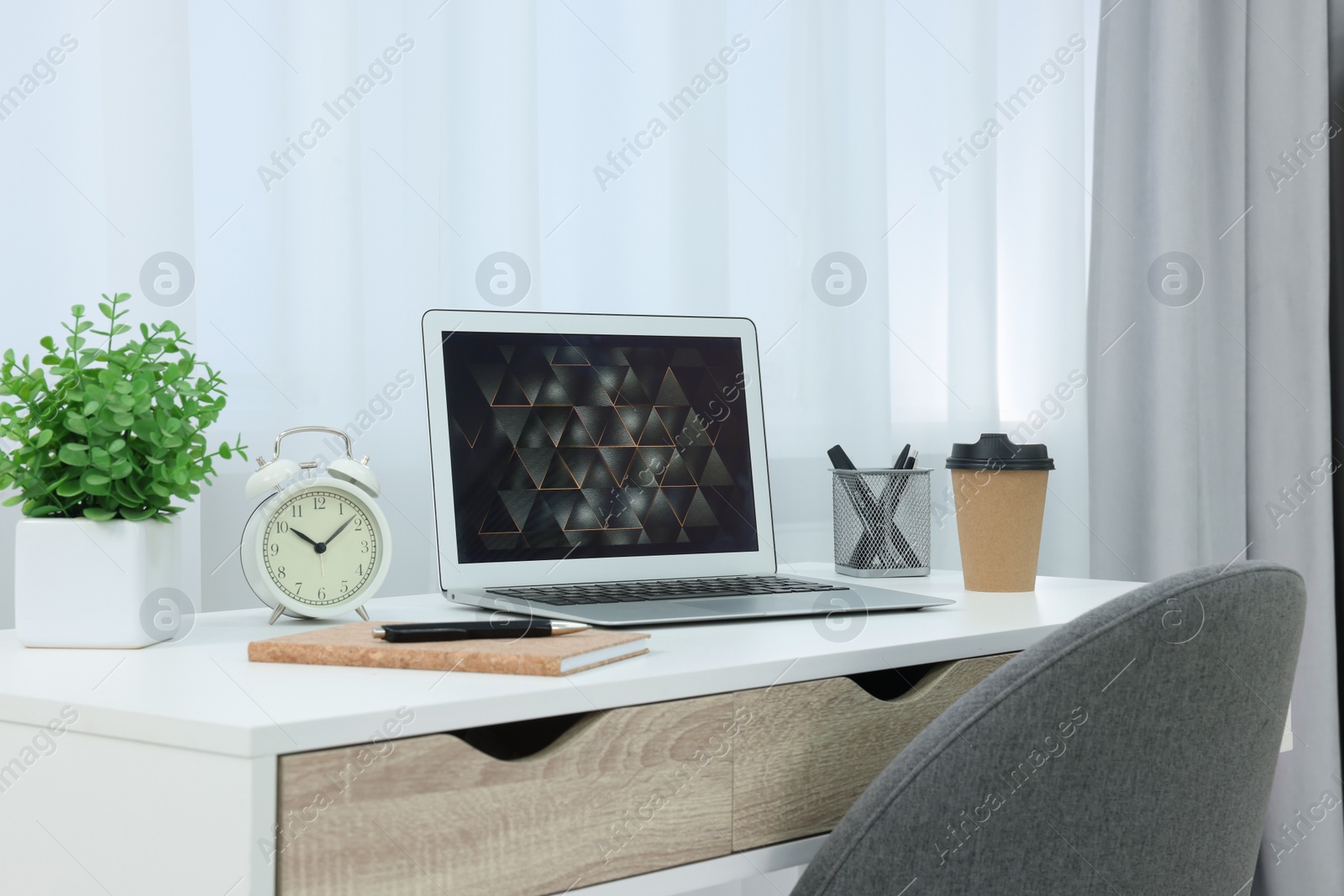 Photo of Workplace with modern laptop on desk at home