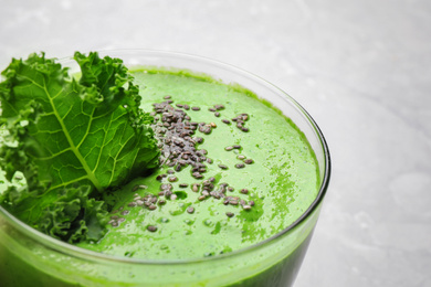 Photo of Tasty kale smoothie with chia seeds on light background, closeup