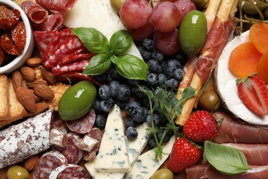Set of different delicious appetizers as background, top view