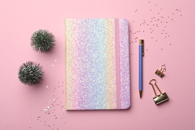 Photo of Bright planner, stationery and festive decor on pink background, flat lay. New Year aims