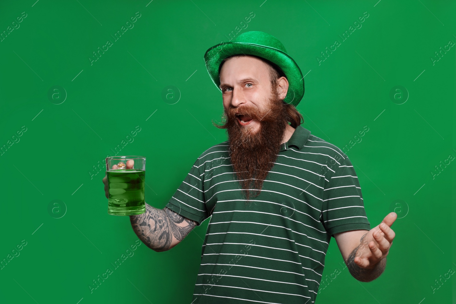 Photo of Bearded man with green beer on color background. St. Patrick's Day celebration