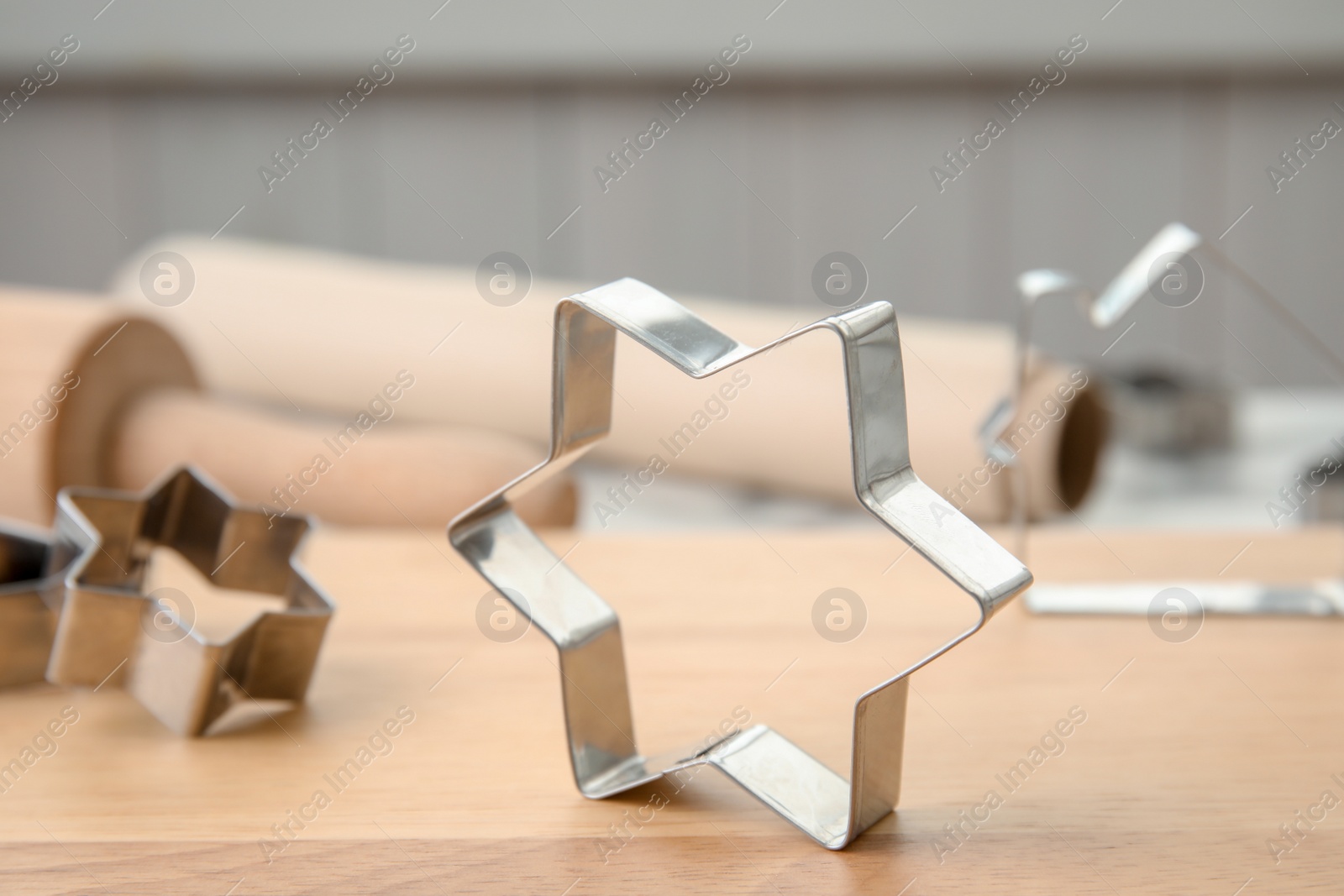 Photo of Cutters for homemade Christmas cookies on wooden board