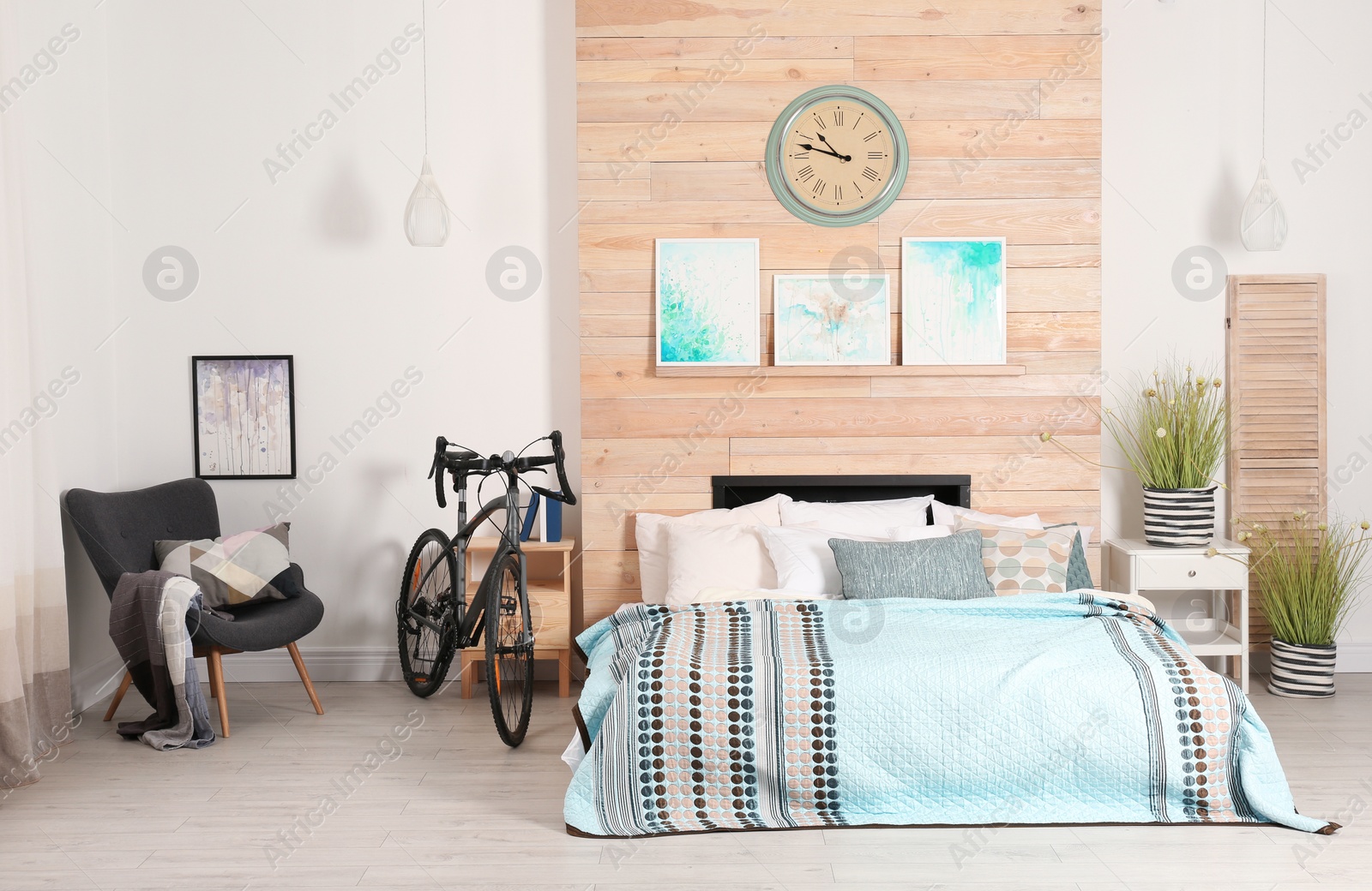 Photo of Modern apartment interior with bicycle near bed