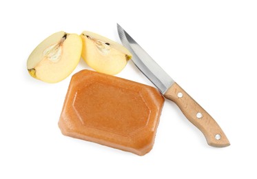 Delicious sweet quince paste, knife and fresh cut fruit isolated on white, top view
