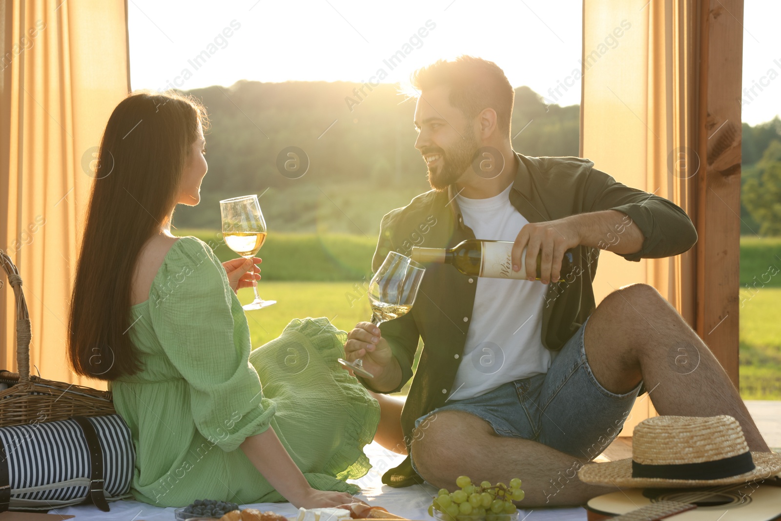 Photo of Romantic date. Beautiful couple having picnic outdoors on sunny day