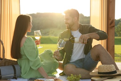 Photo of Romantic date. Beautiful couple having picnic outdoors on sunny day