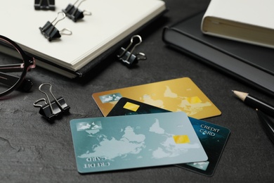 Photo of Credit cards and stationery on black background