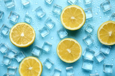 Photo of Ice cubes and cut lemons on turquoise background, flat lay. Ingredients for refreshing drink