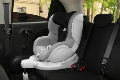 Child safety seat on backseat in car. Danger prevention