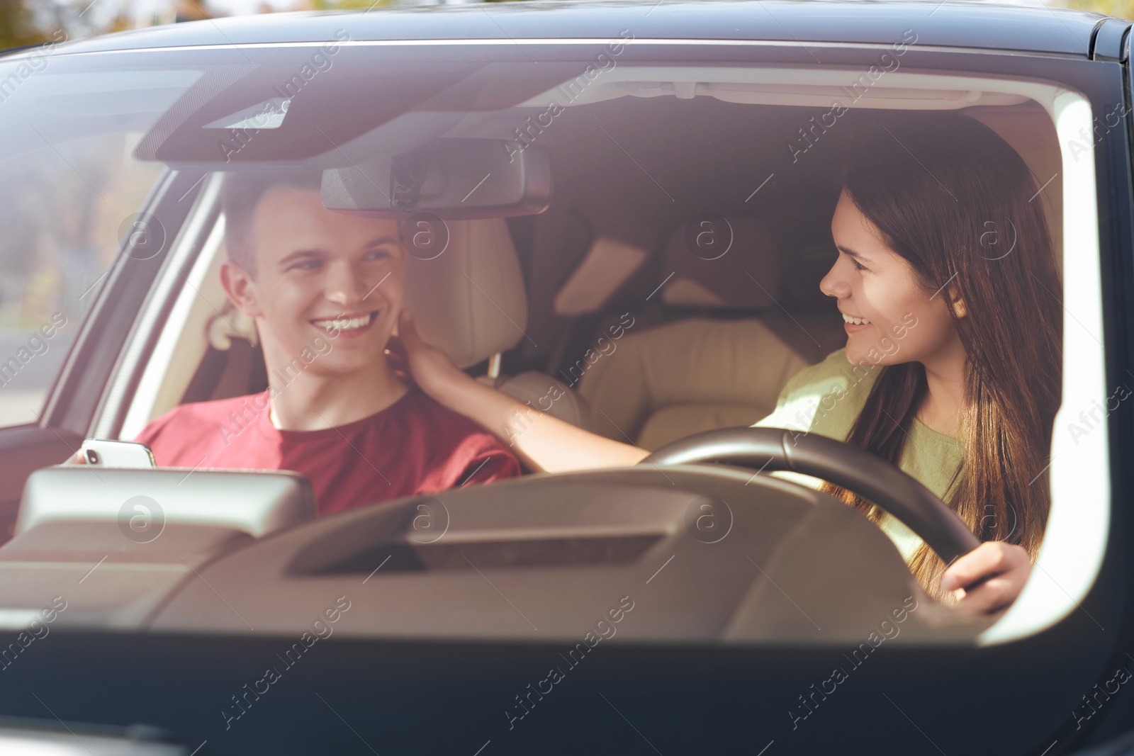 Photo of Happy young couple travelling together by car