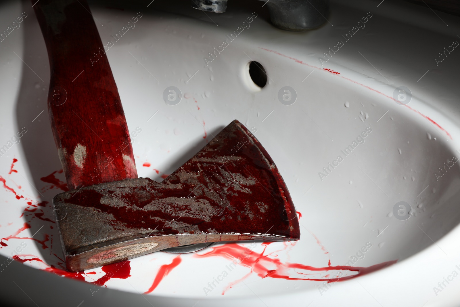 Photo of Axe with blood in sink, closeup view