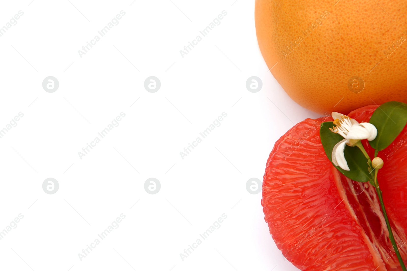 Photo of Fresh grapefruits and green leaves on white background, top view. Space for text