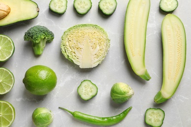 Flat lay composition with fresh vegetables and fruits on light background