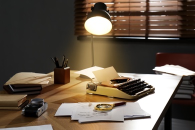 Typewriter, fingerprints and papers on desk in office. Detective's workplace