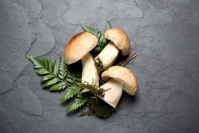 Flat lay composition with porcini mushrooms on grey background