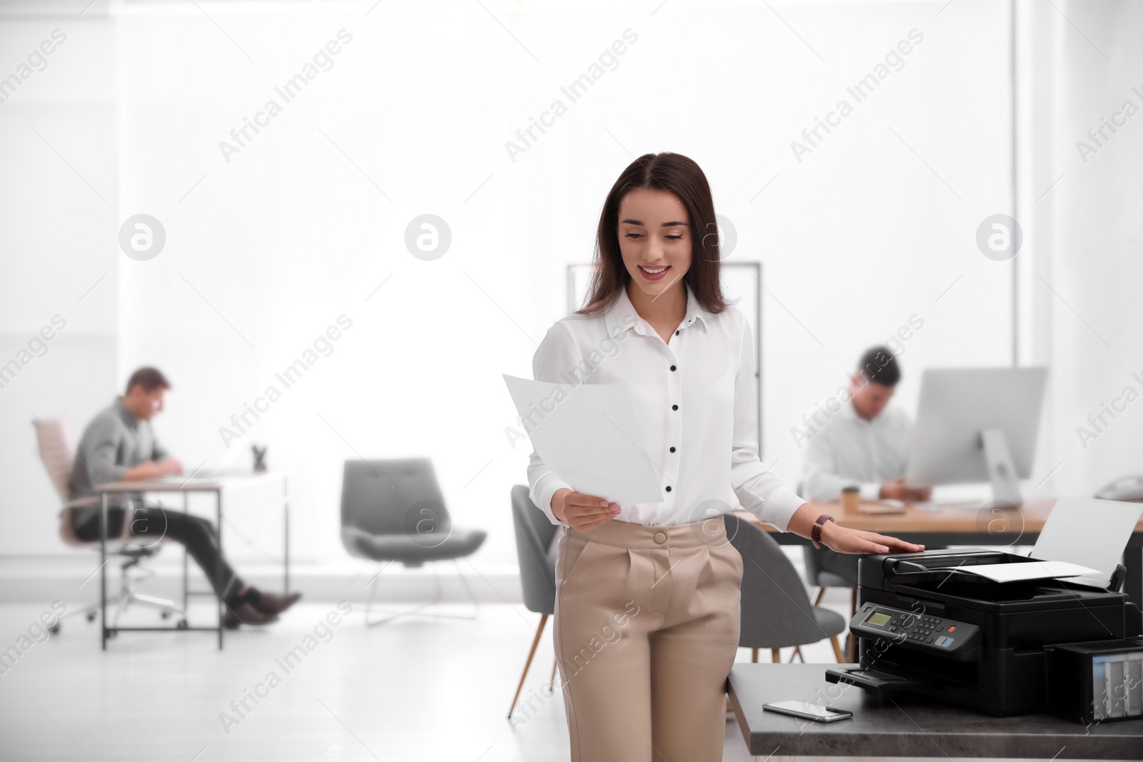 Photo of Employee using new modern printer in office