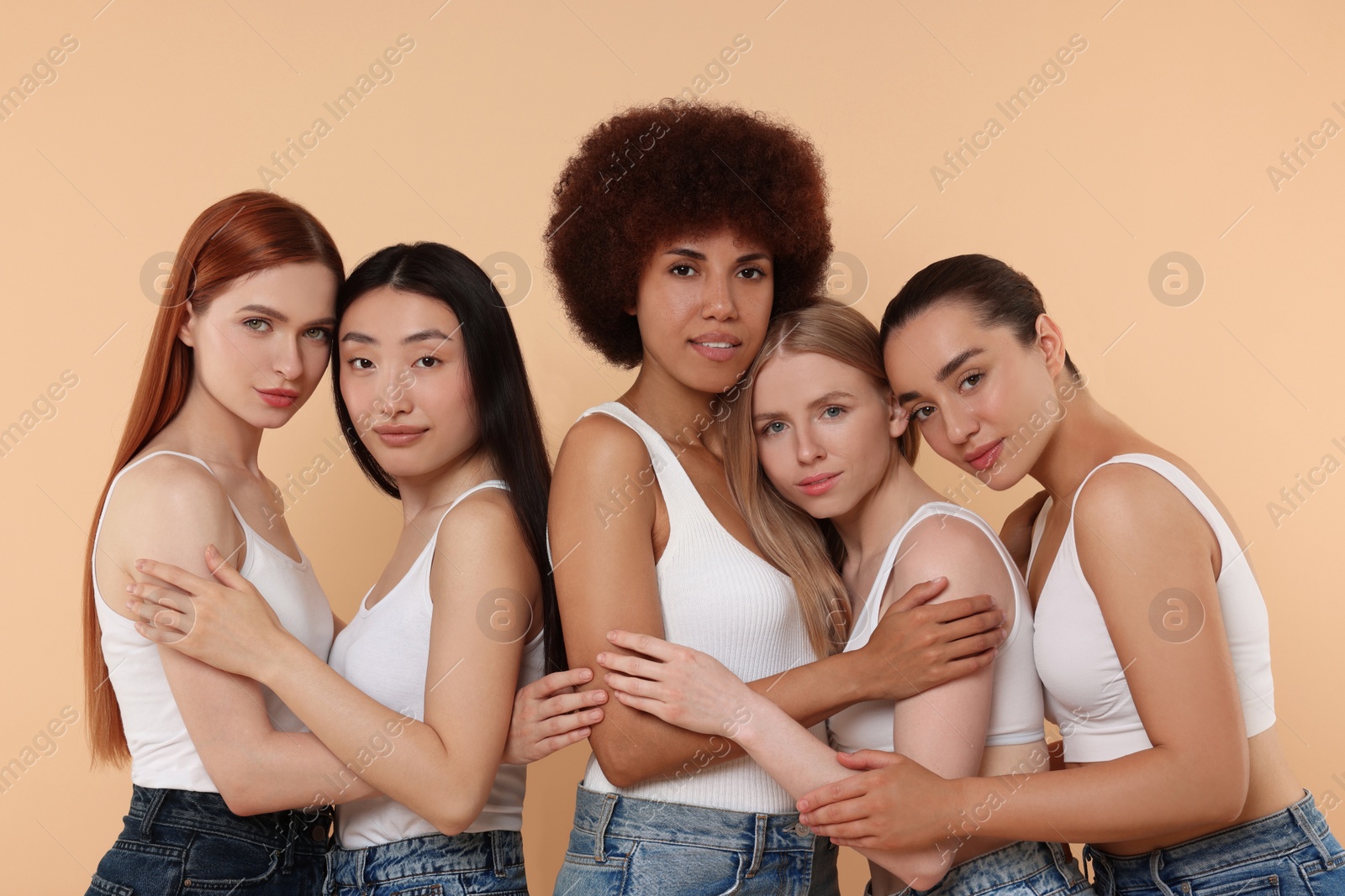 Photo of Portrait of beautiful young women on beige background