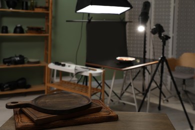 Photo of Professional equipment and composition with tasty dish on table in photo studio, selective focus. Food photography