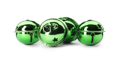 Photo of Shiny green sleigh bells on white background