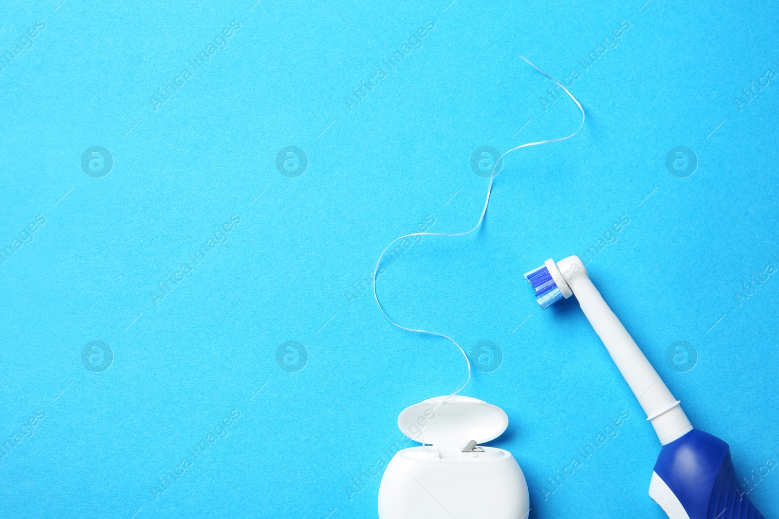 Photo of Flat lay composition with electric toothbrush and dental floss on color background