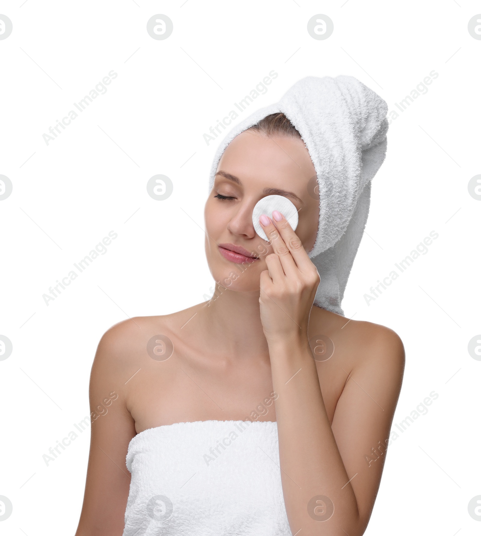 Photo of Young woman cleaning her face with cotton pad on white background