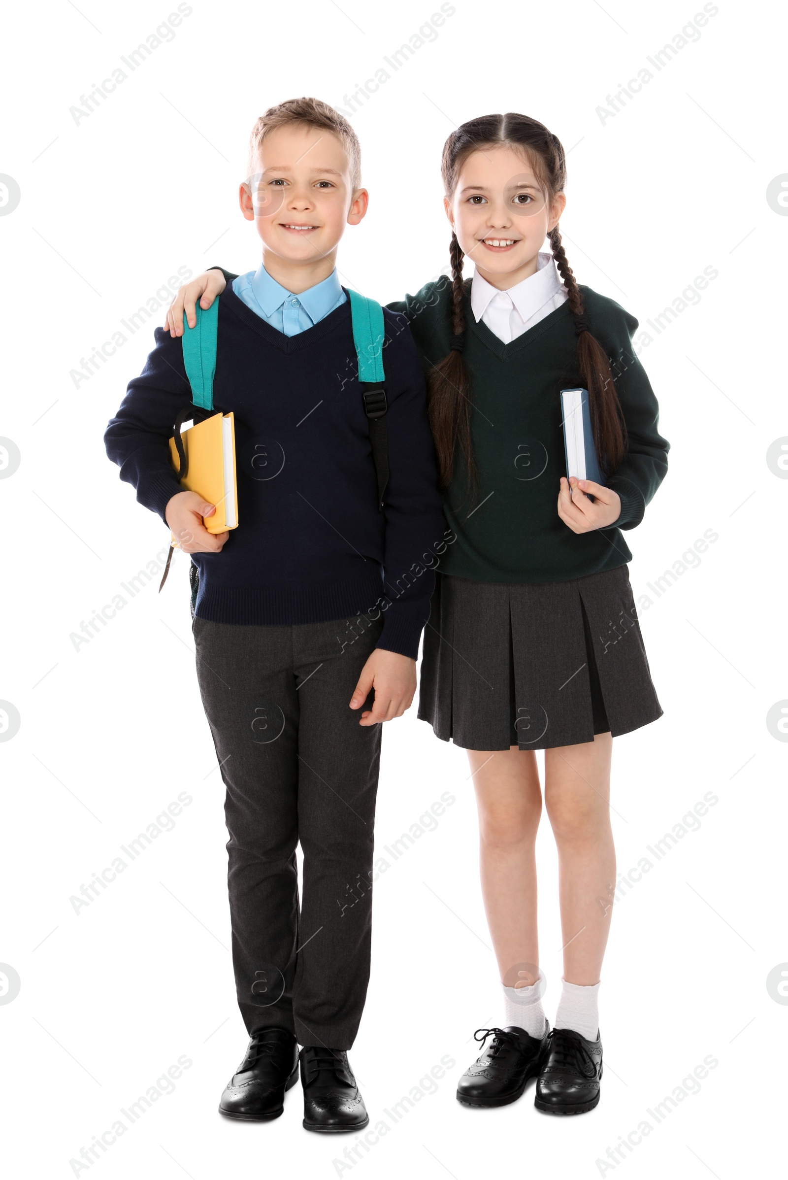 Photo of Full length portrait of cute children in school uniform on white background