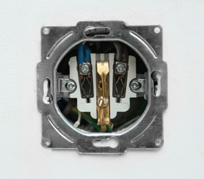 Disassembled socket on white background, closeup. Electrician's equipment