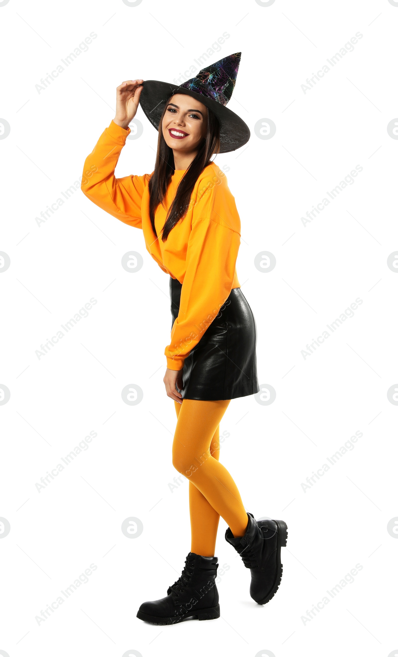 Photo of Beautiful young woman wearing witch costume for Halloween party on white background