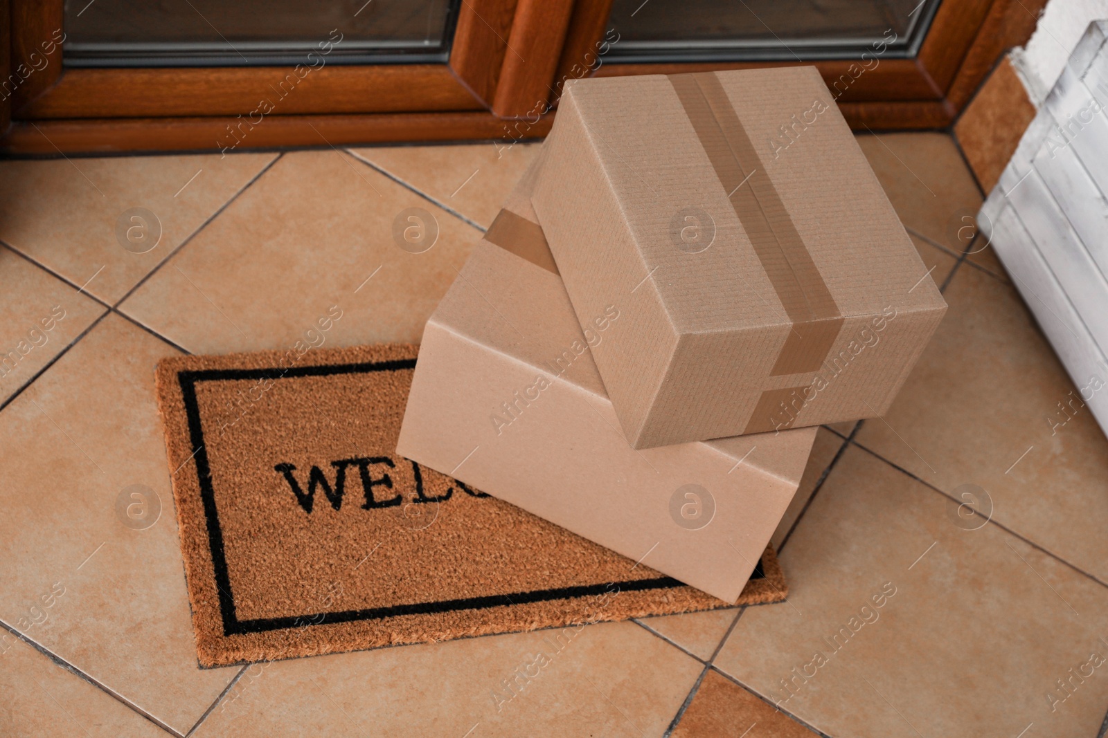 Photo of Parcels delivered on mat near front door