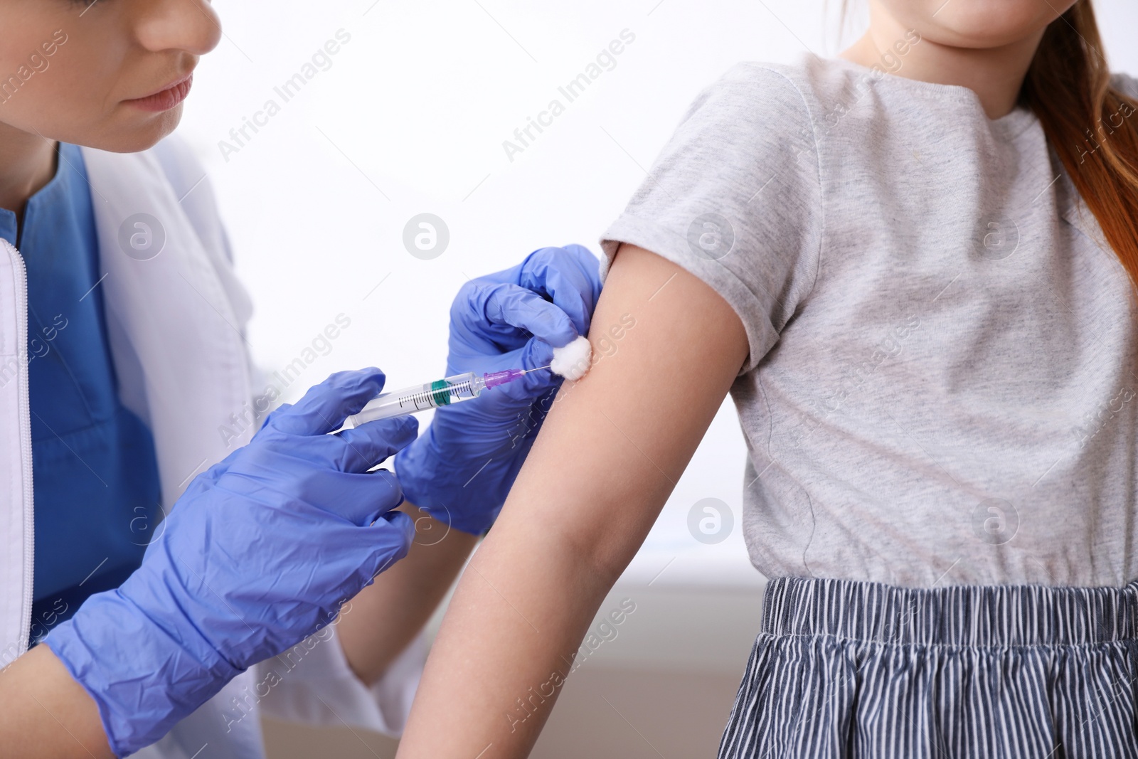 Photo of Little girl receiving chickenpox vaccination in clinic, closeup. Varicella virus prevention