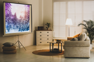 Image of Stylish room with modern video projector and comfortable sofa