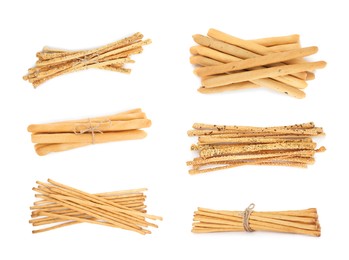 Image of Set with delicious crispy grissini sticks on white background