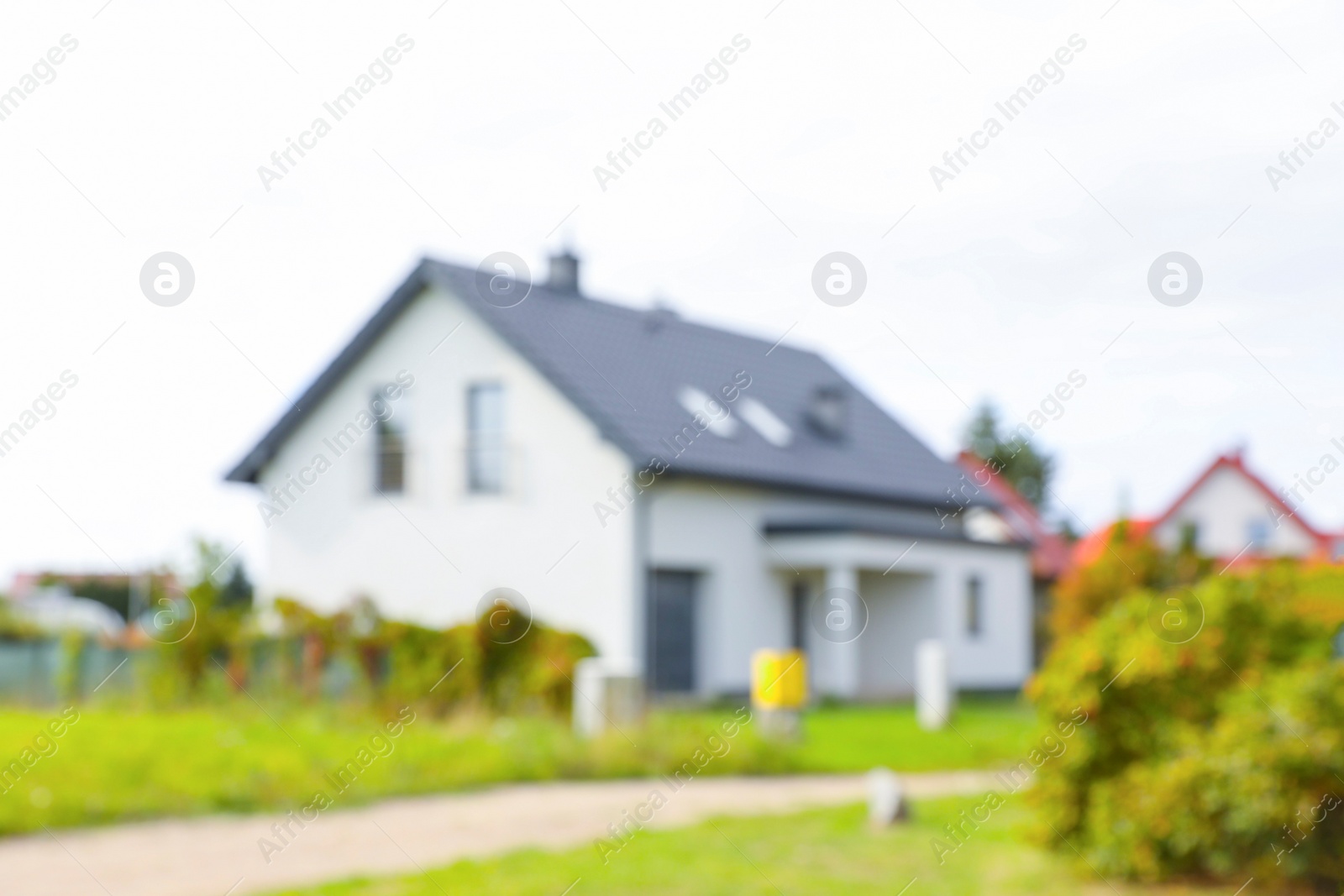 Photo of Blurred view of suburban street with beautiful house