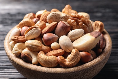 Bowl with organic mixed nuts on table, closeup