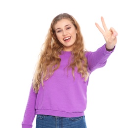 Photo of Happy young woman showing victory gesture on white background